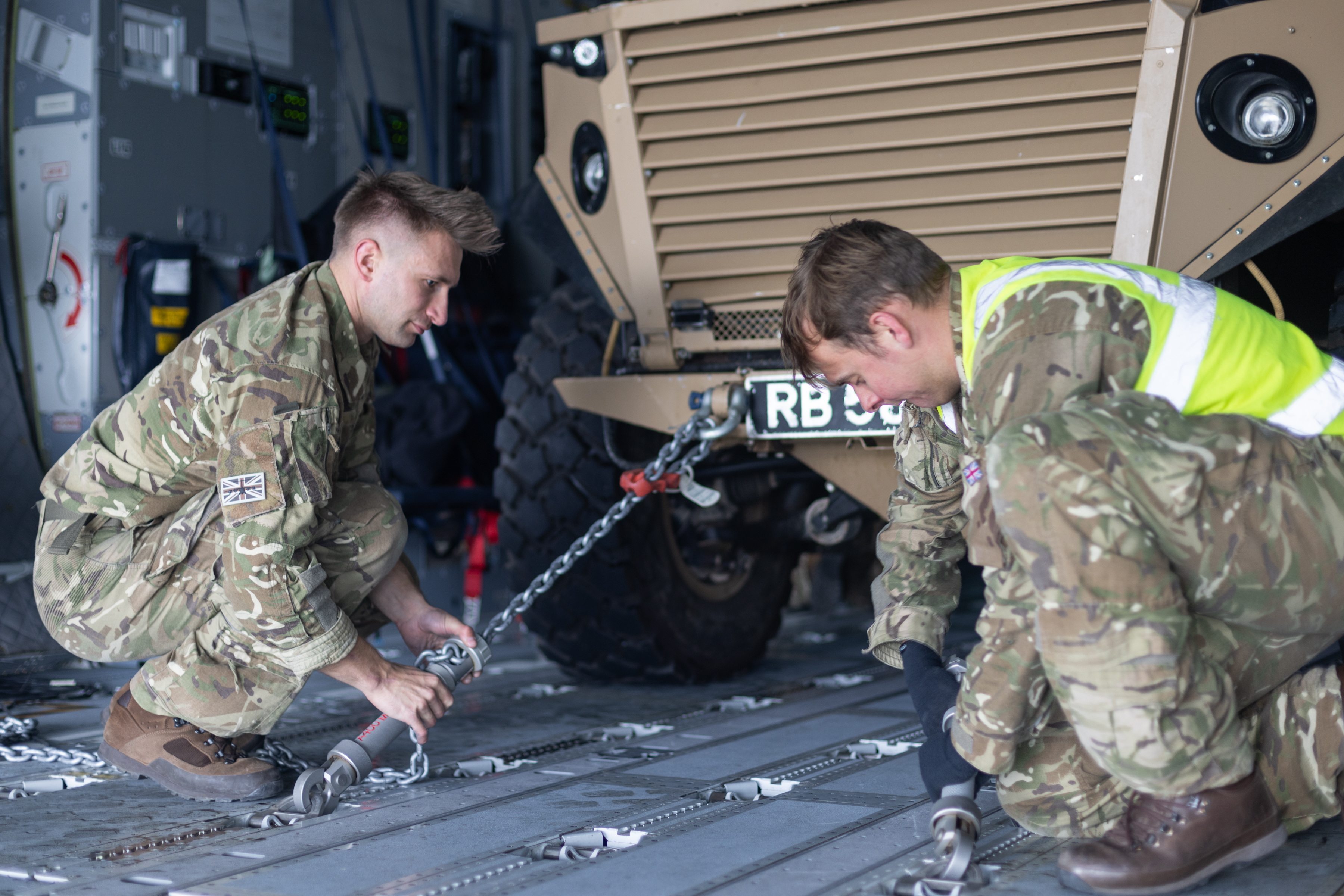 1 Squadron RAF Regiment's Foxhound Armoured Vehicle being secured in an Atlas C Mk.1 aircraft.